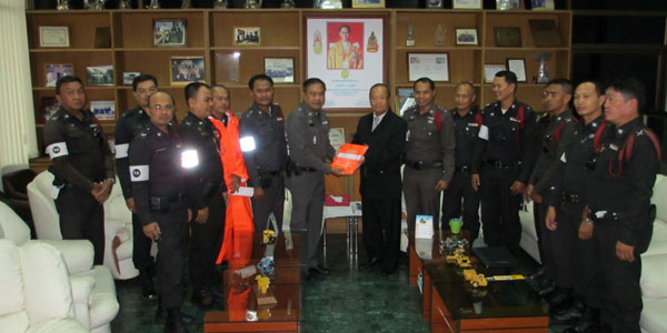 Presents raincoats to local police